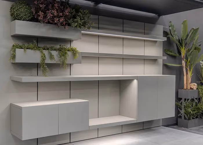 The same grey outdoor wall system with every door closed, shelves and decorative plants.
