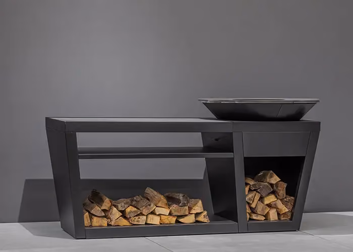 Modern outdoor barbecue with a black metal frame, an integrated hearth and lower bays filled with firewood.