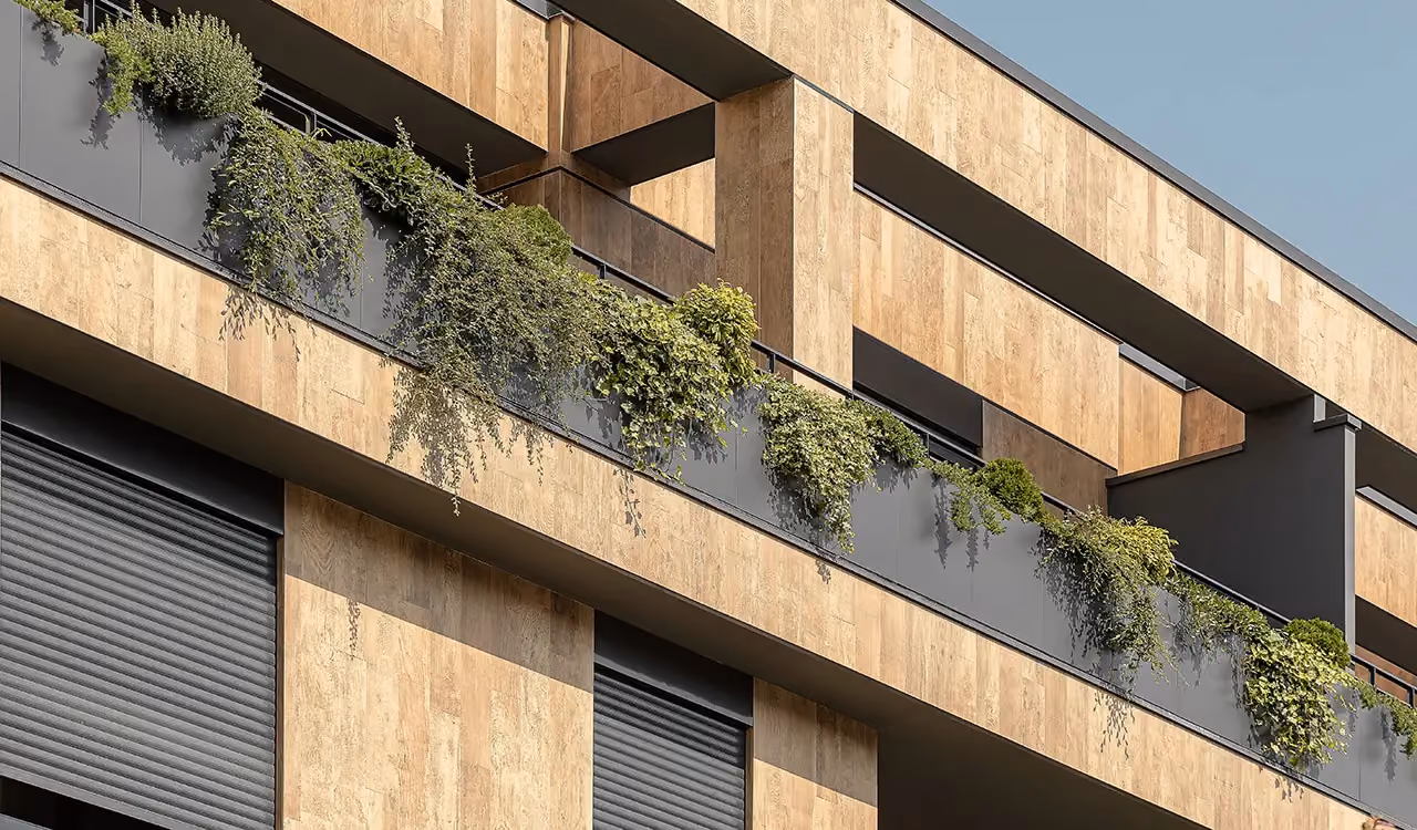 Pale stone façade with linear planters built into the balcony balustrades