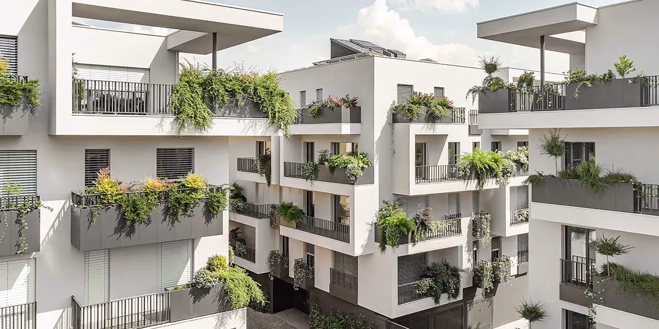 White residential block with planters and screens built into the balconies
